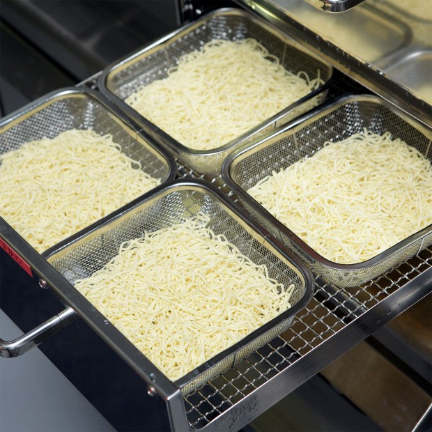 Place the noodles in a colander and steam.