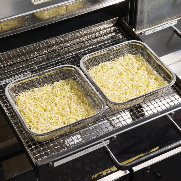 Place the noodles in a colander and steam.