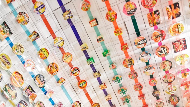 Successive generations of products hover above your head and surround you in this homage to instant noodles' march of time.